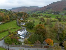 A house surrounded by fields and trees at Goody Raise in Grasmere
