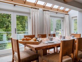 A dining room with a wooden table and chairs at Goody Raise in Grasmere