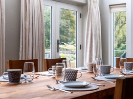 A dining room with a table set for meals at Goody Raise in Grasmere
