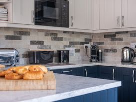 A kitchen with appliances and pastries at Goody Raise in Grasmere