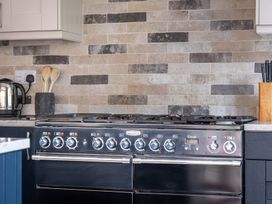 A kitchen with a stove and kettle at Goody Raise in Grasmere