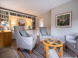 A snug with armchairs and a table at Goody Raise in Grasmere
