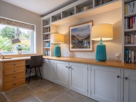 An office with a desk and bookshelf at Goody Raise in Grasmere