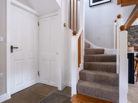 A hallway with stairs and doors at Goody Raise in Grasmere