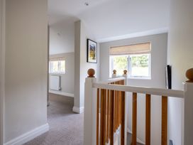 A hallway with windows and a staircase at Goody Raise in Grasmere