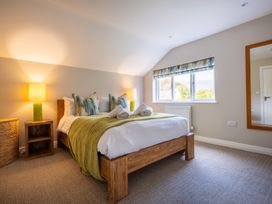 A bedroom with a bed and a lamp at Goody Raise in Grasmere