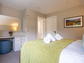A bedroom with a bed and desk at Goody Raise in Grasmere
