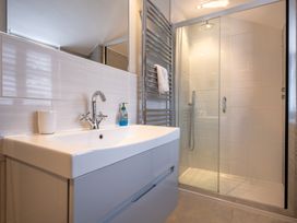 A bathroom with a sink and shower enclosure at Goody Raise in Grasmere