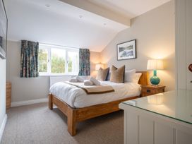 A bedroom with a bed and window at Goody Raise in Grasmere