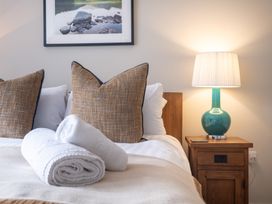 A bedroom with a bed and nightstand at Goody Raise in Grasmere