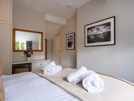 A bedroom with a bed and towels at Goody Raise in Grasmere