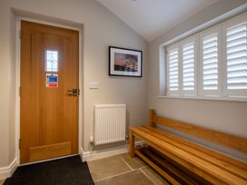 A hallway with a door and a bench at Goody Raise in Grasmere