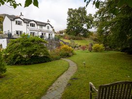 A garden with a house and pathway at Goody Raise in Grasmere