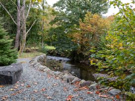 A stream with rocks and trees at Goody Raise in Grasmere