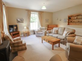 A living room with a sofa and armchairs at Hawkshead Hall in Hawkshead