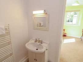 A bathroom with a sink and mirror at Hawkshead Hall in Hawkshead