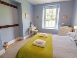 A bedroom with a bed and desk at Hawkshead Hall in Hawkshead