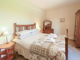 A bedroom with a bed and bedside table at Hawkshead Hall in Hawkshead
