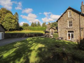 An outdoor view of a house and garden at Hawkshead Hall in Hawkshead