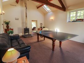 A recreation room with a ping pong table and sofa at Hawkshead Hall in Hawkshead