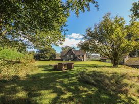 An outdoor area with a table and a house at Hawkshead Hall in Hawkshead