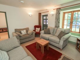 A living room with sofas and a coffee table at Rose Cottage Coniston