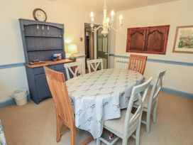 A dining room with a table and chairs at Rose Cottage Coniston