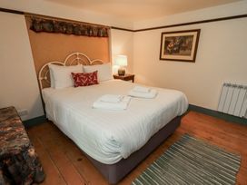 A bedroom with a bed and bedside table at Rose Cottage Coniston
