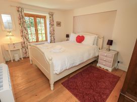 A bedroom with a bed and bedside table at Rose Cottage Coniston