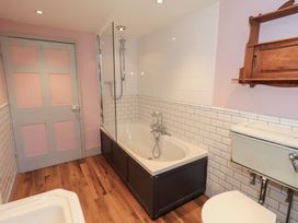 A bathroom with a bathtub, shower, and toilet at Rose Cottage Coniston