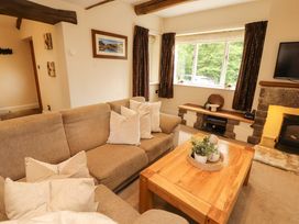 A living room with a sofa and coffee table at Durham Bridge Barn in Crosthwaite