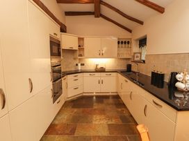 A kitchen with cabinets and appliances at Durham Bridge Barn in Crosthwaite