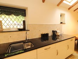 A kitchen with sink and kettle at Durham Bridge Barn in Crosthwaite