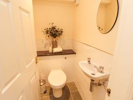 A bathroom with a toilet and sink at Durham Bridge Barn in Crosthwaite