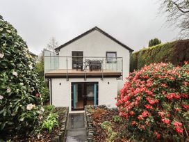 A house with balcony and garden flowers at Striding Home in Ambleside