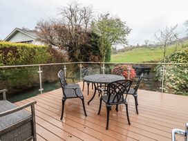 A patio with a table and chairs at Striding Home in Ambleside
