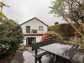 A house with a balcony and outdoor seating area at Striding Home in Ambleside