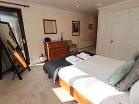 A bedroom with a bed and dresser at Gillybeck in Ambleside