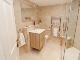 A bathroom with a sink, toilet, and shower at Chapelside Cottage in Ambleside