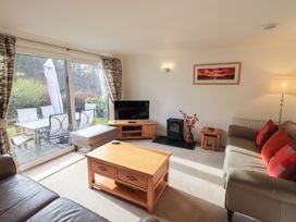 A living room with a television and sofa at Mardale in Ambleside