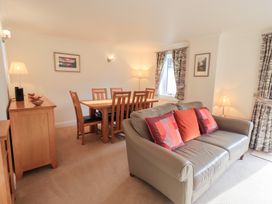 A living room with a sofa and dining area at Mardale in Ambleside