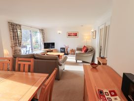 A living room with a television and sofa at Mardale in Ambleside
