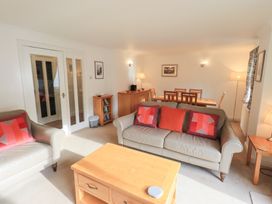 A living room containing a sofa and dining table at Mardale in Ambleside