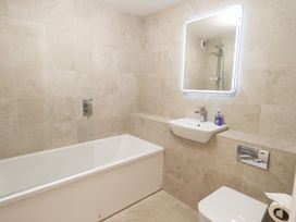A bathroom with a bathtub, sink, and toilet at Mardale in Ambleside