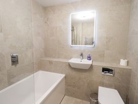 A bathroom with a bath tub and sink at Mardale in Ambleside