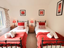 A bedroom with two beds and lamps at Mardale in Ambleside