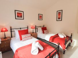 A bedroom with two beds and lamps at Mardale in Ambleside