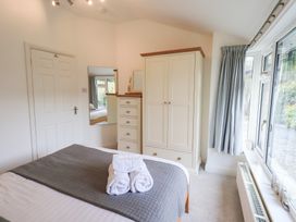 A bedroom with a bed and wardrobe at Mardale in Ambleside