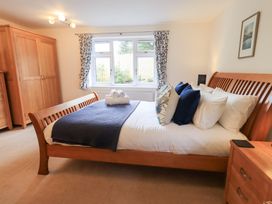 A bedroom with a bed and wardrobe at Mardale in Ambleside