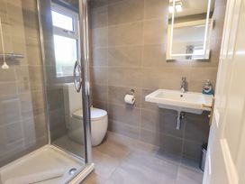 A bathroom with a shower, toilet and sink at Mardale in Ambleside